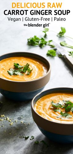 two bowls filled with carrot ginger soup and garnished with cilantro