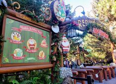 the entrance to disneyland's santa clause village is decorated with christmas decorations and lights