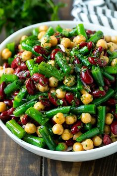 a white bowl filled with beans and green beans