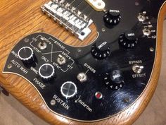 an electric guitar with many knobs on it