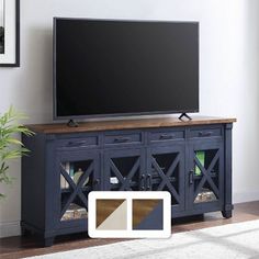 a flat screen tv sitting on top of a wooden entertainment center