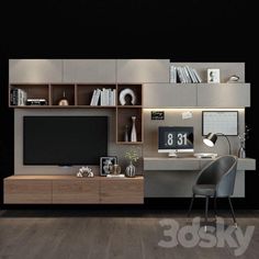 a room with a desk, chair and television on the wall next to bookshelves