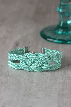 a green bracelet sitting on top of a table