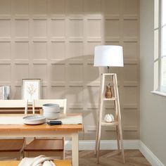 a living room scene with focus on the dining table and chair, along with a lamp