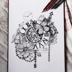 a drawing of a clock surrounded by flowers and butterflies on a sheet of white paper