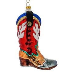 a cowboy boot ornament hanging from a christmas tree