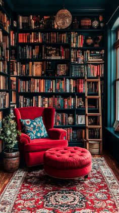 a red chair sitting in front of a bookshelf filled with lots of books