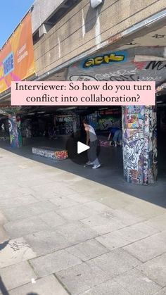 an interviewer is standing in front of a graffiti covered building with the caption's video below it