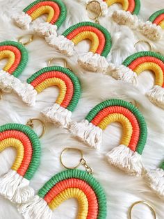 multicolored earrings with tassels and gold rings on white furnishing