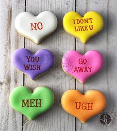 four conversation hearts with i don't like u written on them in different colors