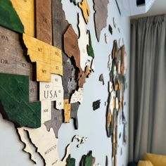 a wooden map of the world hanging on a wall