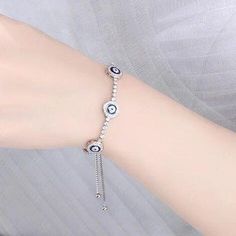 This sterling silver and cubic zirconia bracelet features three blue evil eyes - one to ward off envy, one to protect from harm and the last to attract good fortune. Made from durable 925 sterling silver and sparkling cubic zirconia stones, this Turkish evil eye bracelet will provide spiritual protection and positive energy wherever you go. Slip it on to shield yourself from bad vibes at work, while traveling or anytime you need an extra boost of confidence - the eye will do the rest for you. Th Turkish Evil Eye, Cubic Zirconia Bracelet, Bad Vibes, Evil Eyes, Spiritual Protection, Silver Jewelry Earrings, Handmade Fashion Jewelry, Blue Evil Eye, Eye Bracelet