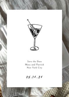 a white card with a black ink drawing of a martini on it and the text save the date