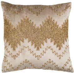 a gold and white pillow on a white background