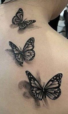 three butterflies on the back of a woman