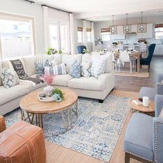 a living room filled with furniture and lots of windows