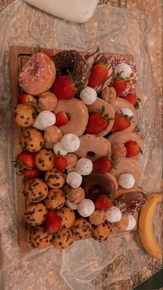 an assortment of doughnuts and pastries on a tray