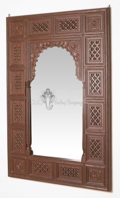 an ornate wooden mirror frame with carvings on the front and sides, made out of wood