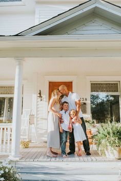 a family standing in front of a house