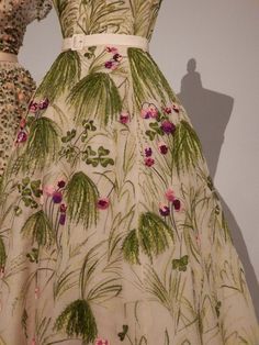 a dress with pink flowers and green leaves on it