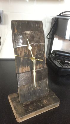 a clock made out of wood sitting on top of a counter