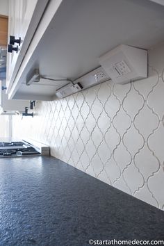 a stove top oven sitting inside of a kitchen next to a wall mounted range hood