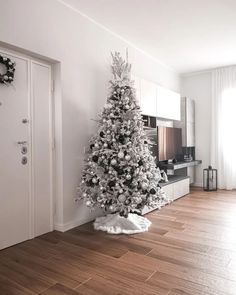 a white christmas tree in the corner of a room