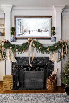 a fireplace decorated for christmas with stockings and ornaments