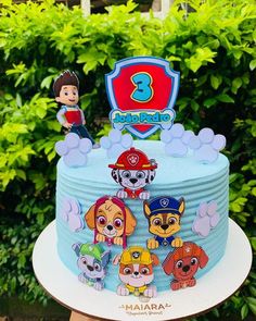 a blue cake with cartoon characters on it