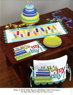 a table topped with cake and decorations on top of a wooden table covered in paper