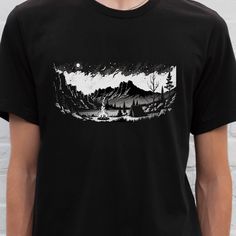 This t-shirt is a must-have for any nature lover. The design showcases a breathtaking mountain landscape with a campsite in the foreground, making it a perfect choice for anyone who loves the great outdoors. The black color of the shirt enhances the contrast between the design and the background, making it even more visually striking. Made from high-quality materials, this t-shirt is both comfortable and durable, ensuring that it will last for years to come. Whether you wear it on your next camp Black Graphic Tee For Camping, Black Graphic Print T-shirt For Camping, Black Custom Print T-shirt For Outdoor Activities, Graphic Print Crew Neck Camp Shirt For Adventure, Adventure Graphic Print Crew Neck Camp Shirt, Adventure Shirts, Camp Shirts, Mountain Camping, Adventure Shirt