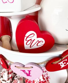 red and white valentine's day decorations are on display in front of other items