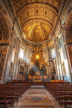 the interior of an old church with gold and white decorations on the walls, ceiling and pews