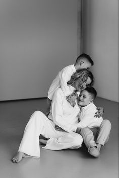 a woman and two children are sitting on the floor