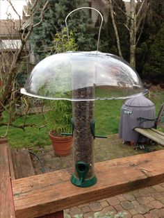 a bird feeder with an umbrella attached to it