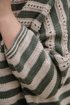 a woman wearing a green and white striped sweater