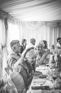 a group of people sitting around a long table