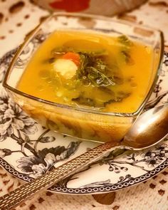 a bowl of soup is sitting on a plate