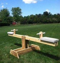 two wooden benches sitting on top of a lush green field