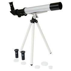 an astronomical telescope on a tripod with three black and white objects in the foreground