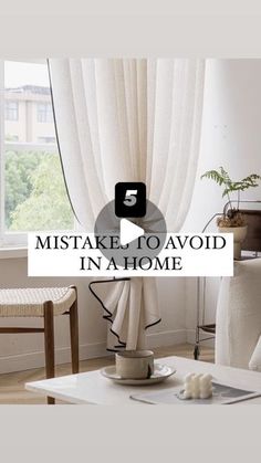 a living room with white furniture and curtains