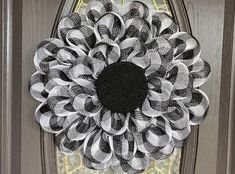 a black and white wreath on the front door