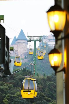 a yellow cable car going up the mountain