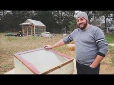 a man standing next to a wooden box