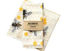 bees and honeycombs printed on white cotton napkins with brown tags in the middle