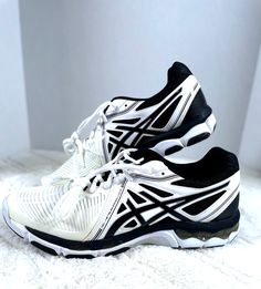 a pair of white and black running shoes