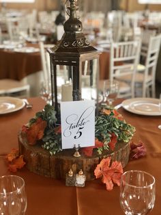 the table is set with an old fashioned lantern and place cards for guests to write their names