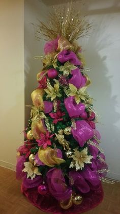 a decorated christmas tree with purple and gold decorations