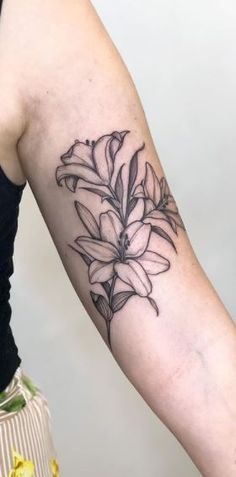 a woman's arm with a flower tattoo on it