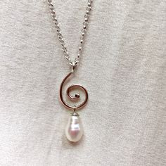 "A gorgeous sterling silver pearl drop necklace, with a textured silver spiral. * 9.5 x 6mm teardrop freshwater pearl  * handmade sterling silver spiral * 18\" / 45cm sterling silver chain * 1\" / 2.5cm pendant length  This one of a kind pearl pendant features a textured silver spiral and a beautiful, lustrous freshwater pearl. Perfect as a stacking necklace, a gift for mum, for bridal jewellery, beach weddings, a 30th wedding anniversary gift for her, or a lovely treat for yourself. I hand make Elegant Sterling Silver Swirl Necklace, Unique Pearl Jewelry, Black Pearl Bracelet, Spiral Necklace, Pearl Drop Necklace, Pendant Necklace Silver, Stacked Necklaces, Beach Weddings, Pearl Pendant Necklace